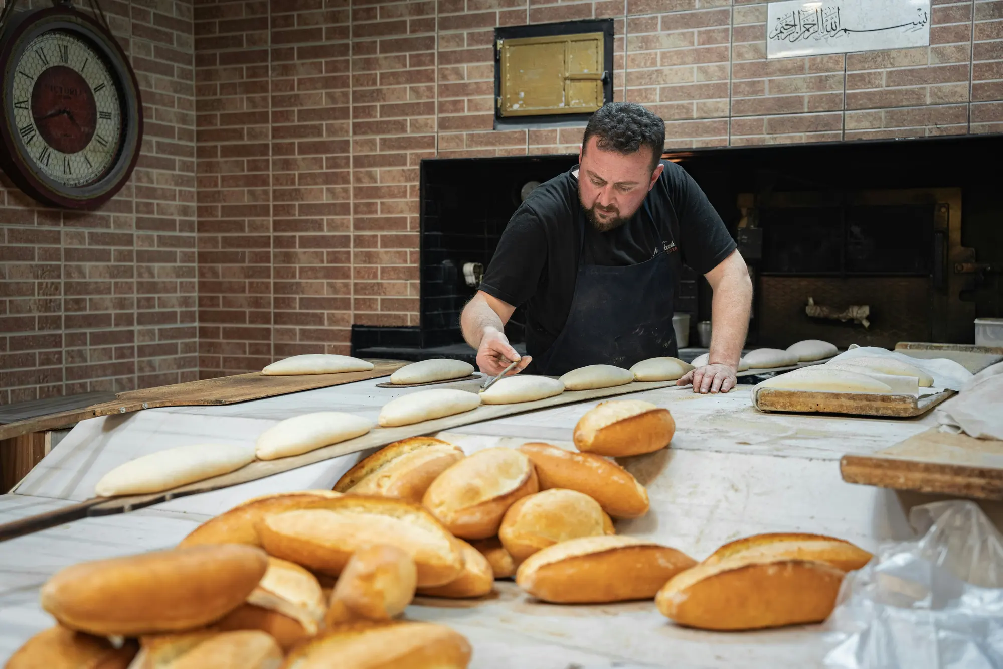 A baker shaping loaves